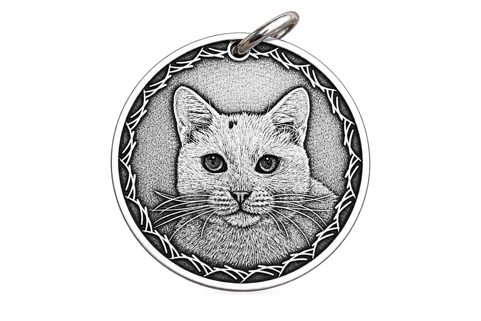 The same white cat's face hand-engraved on a sterling silver coin