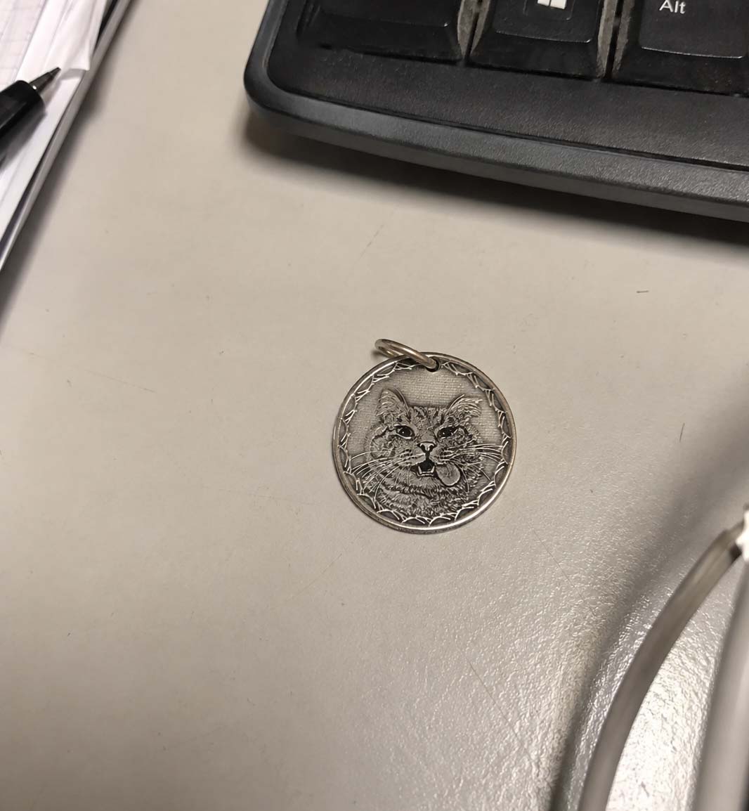 A hand-engraved silver pet coin kept close