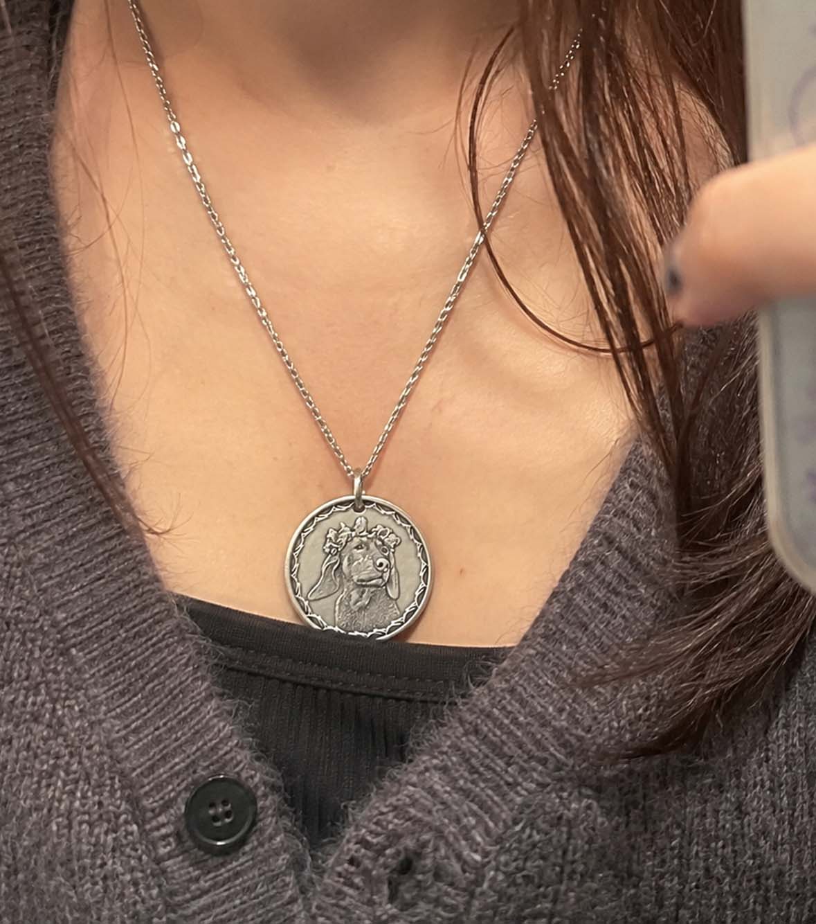A hand-engraved silver pet coin kept close